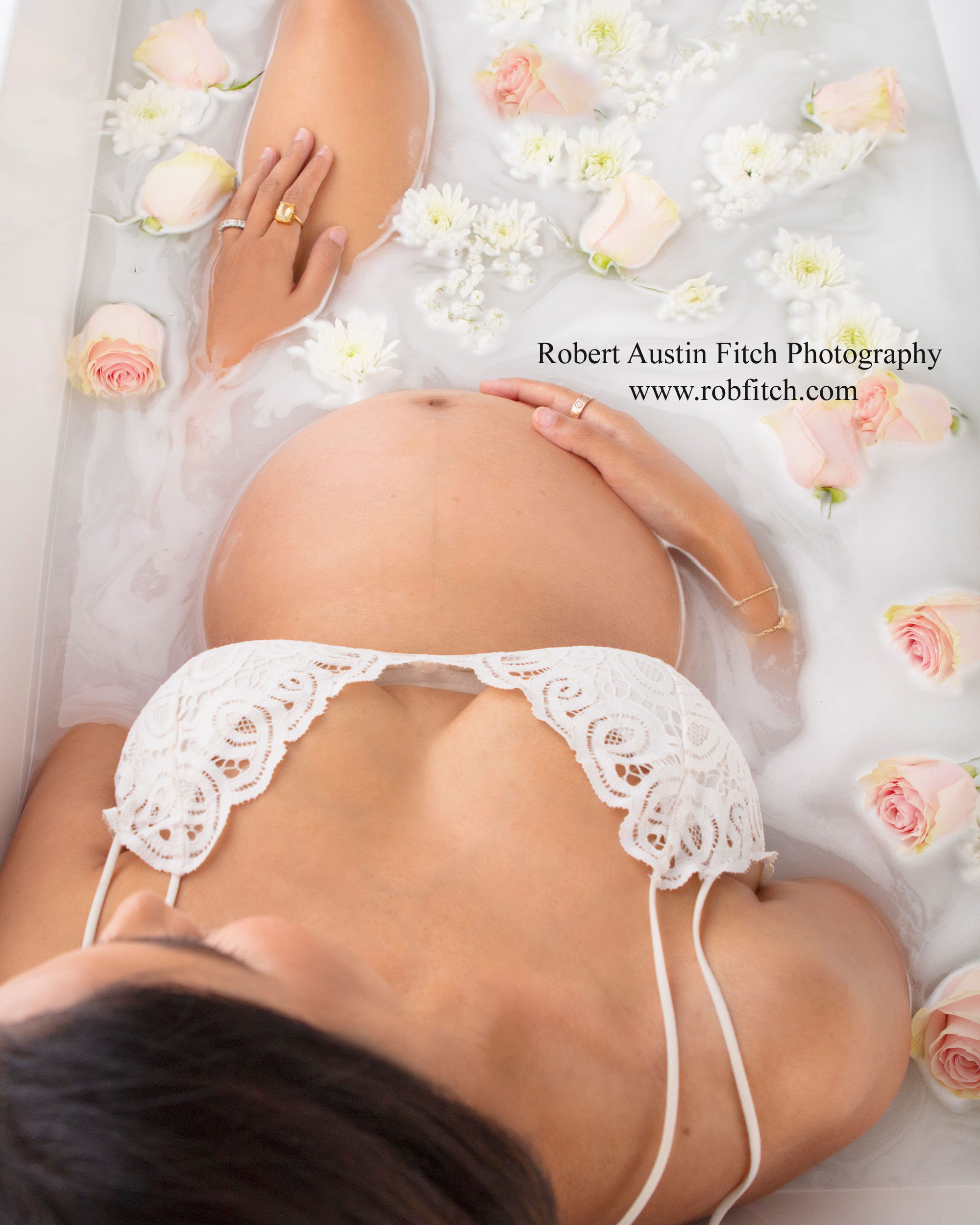 Beautiful milk bath maternity photograph with pink roses