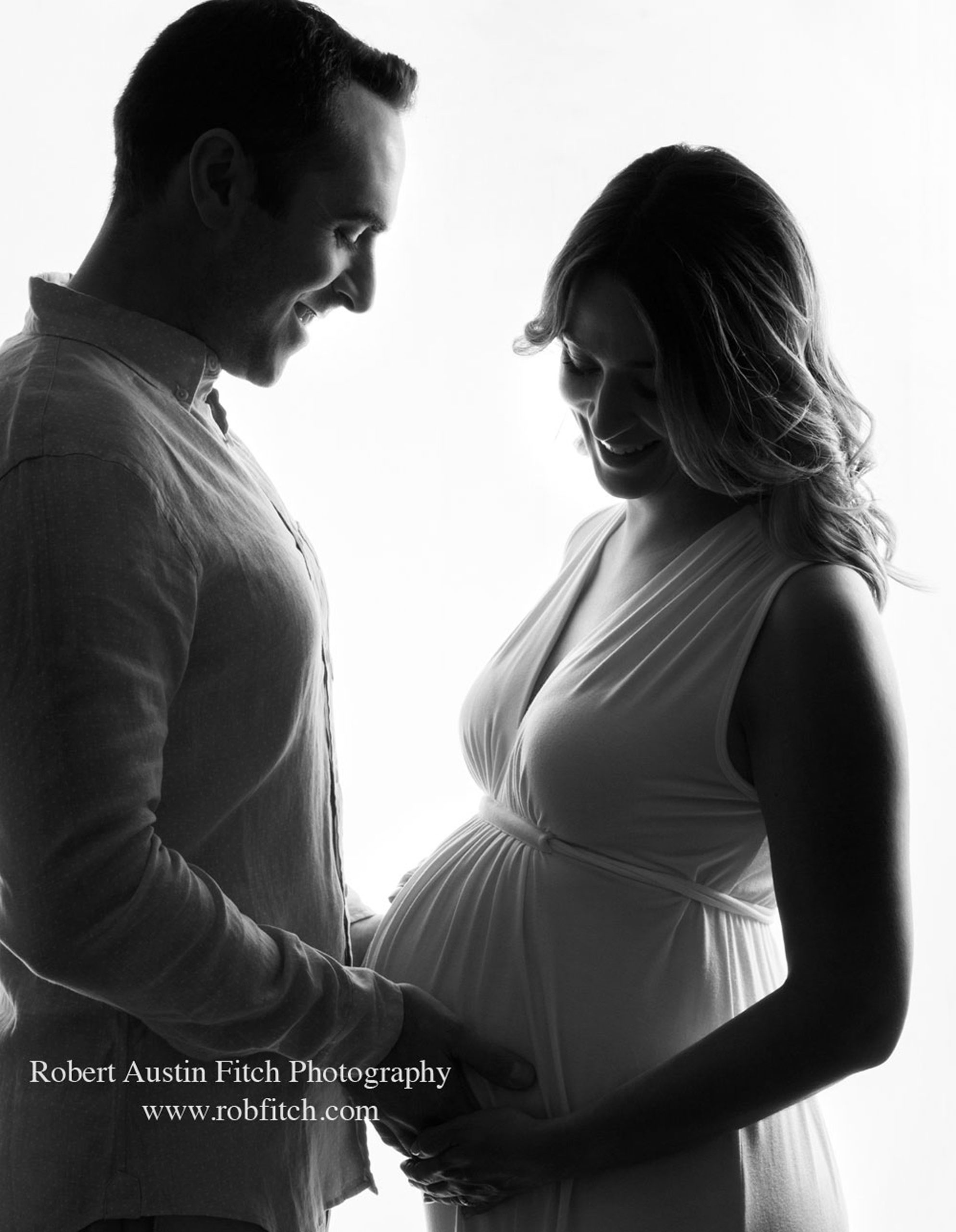 B&W artistic silhouette maternity photo of pregnant woman with her husband