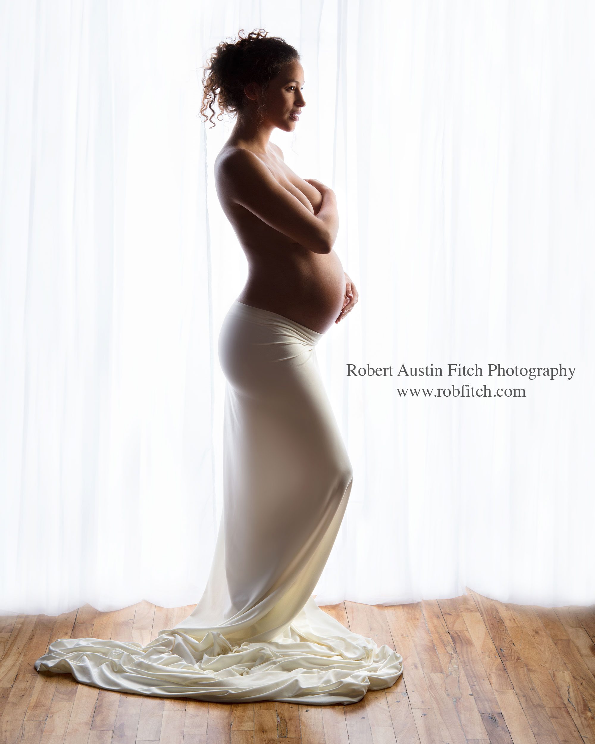 Beautiful color silhouette maternity photo of woman white fabric draping