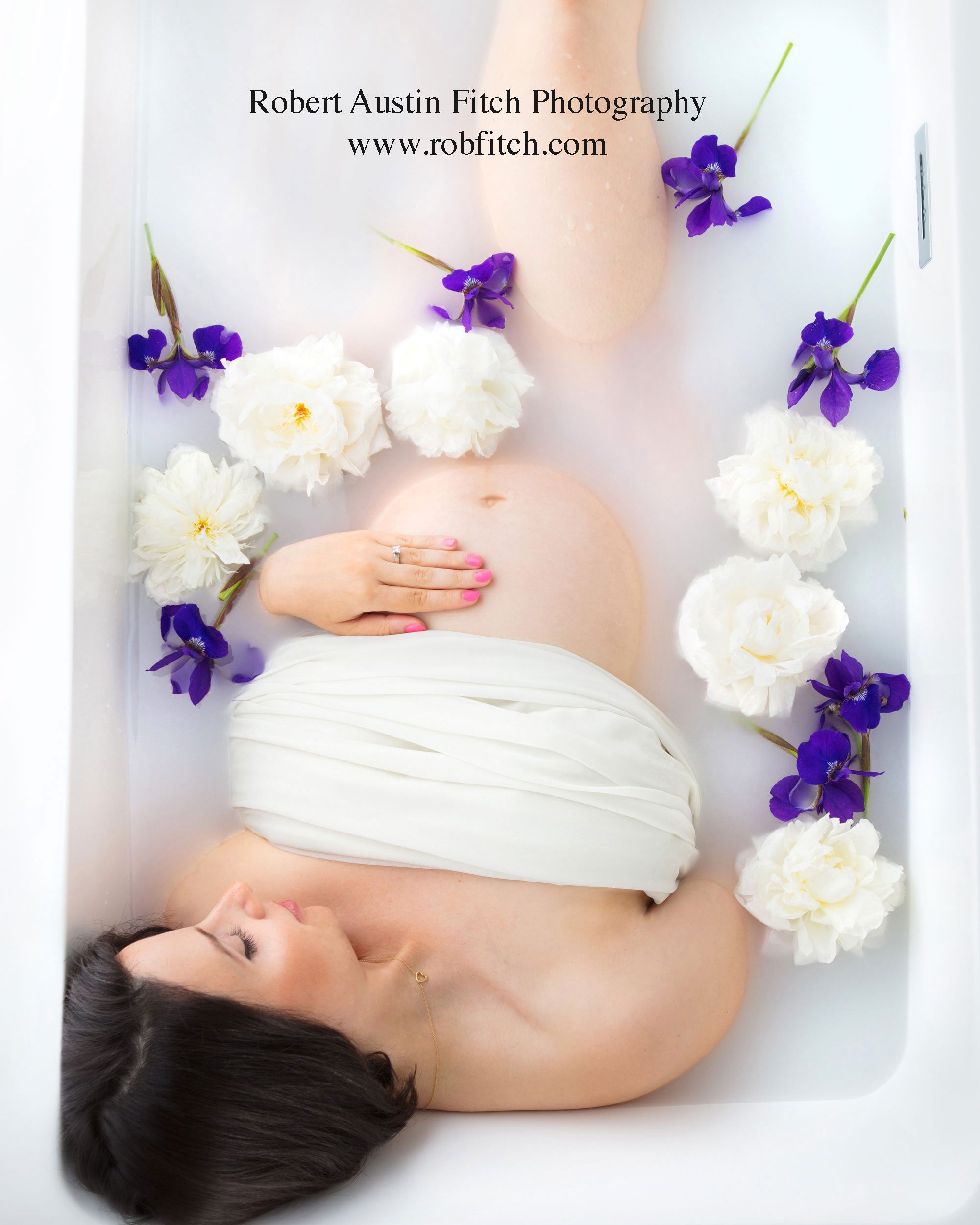 Beautiful milk bath maternity photo with irises and peonies