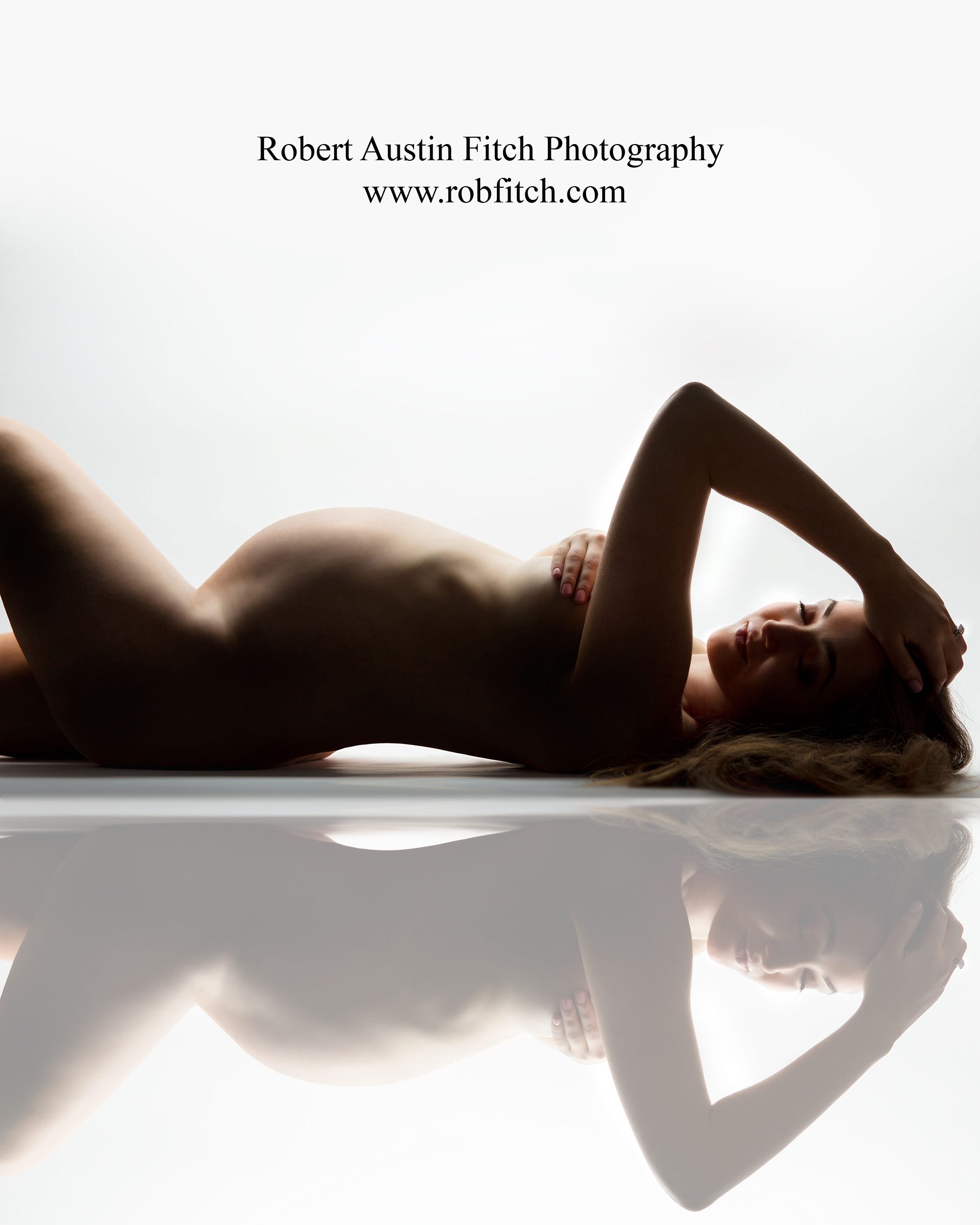 Artistic nude maternity photo in color of reclining pregnant woman