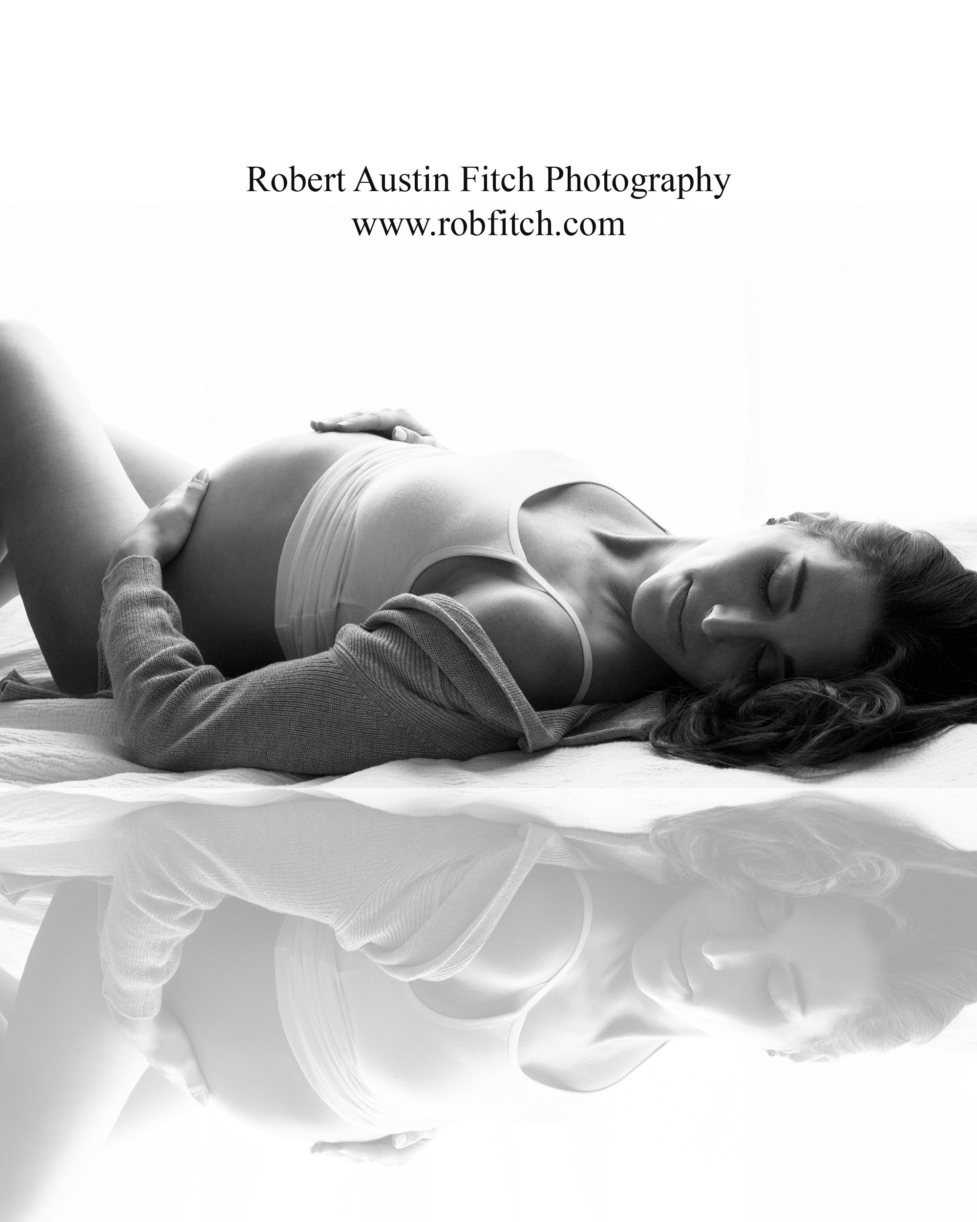 B&W silhouette maternity photo of pregnant woman laying down with reflection