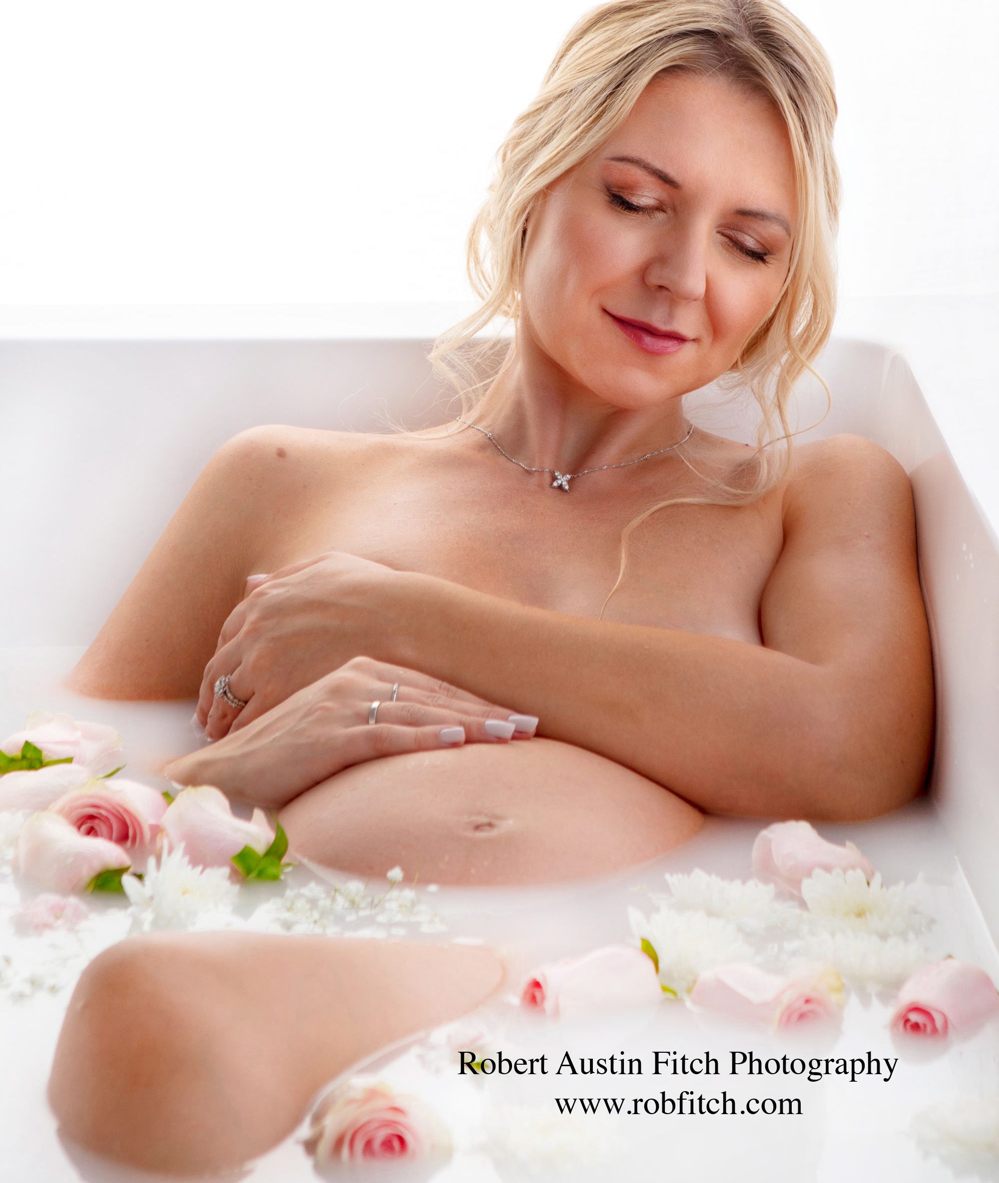 Milk bath maternity portrait of pregnant woman. 